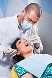 Female patient having her teeth examined by specialist