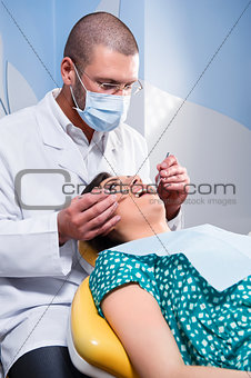 Female patient having her teeth examined by specialist 