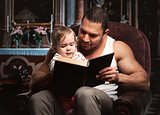 Father reading book to daughter