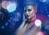 Beautiful woman with creative bright make-up over glowing lights
