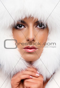 Portrait of a beautiful woman in white fur cap