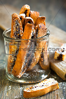 Biscotti with chocolate in a glass jar.