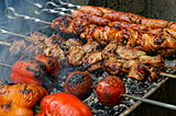 Grilled sausages, meat and vegetables on barbecue