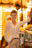 Portrait of smiling young woman riding on carousel