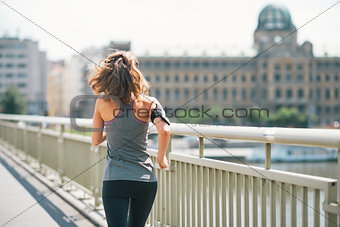 Fitness young woman jogging in the city. rear view