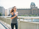 Fitness young woman jogging in the city