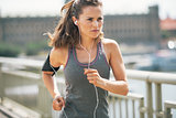 Fitness young woman jogging in the city