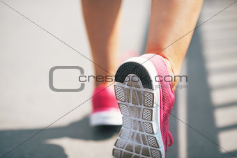 Closeup on sneaker of fitness young woman