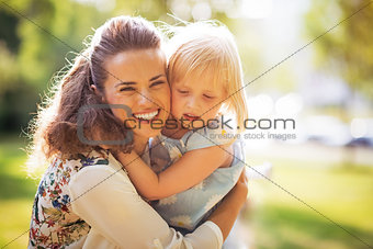 Portrait of happy mother and baby girl hugging