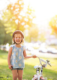 Portrait of happy baby girl with bicycle