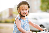 Portrait of baby girl sitting on bicycle
