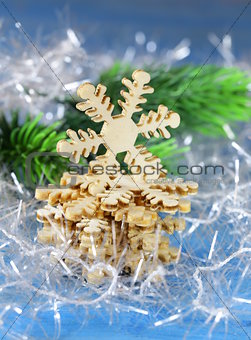 Christmas still life with decorations and wooden snowflakes on a blue background