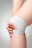 Injured knee with bloody bandage
