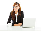 young confident business woman sitting with laptop