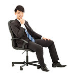 confident Young business man sitting in a chair