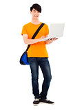confident young student standing and using laptop