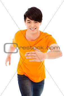 Young happy man make a running pose