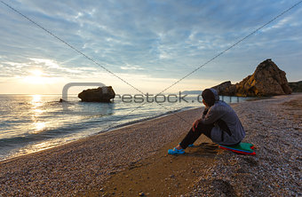 Woman on Potistika beach. Sunrise view (Greece)