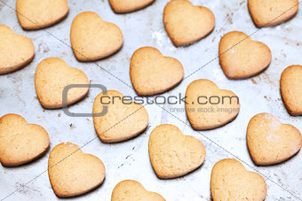 Home made shortbread heart shaped cookies on baking tray