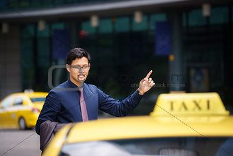 asian businessman calling taxi car leaving work 
