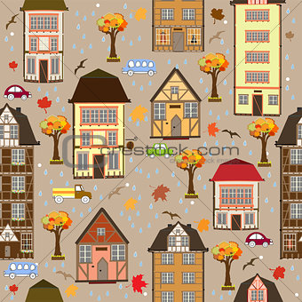 Seamless pattern with autumn city. Vector decorative timber frame houses under falling leaves. City district