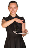 Beautiful girl in dress holding tablet and covers it