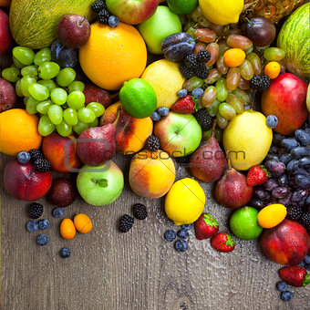 Organic Fruits  with water drops on dark wooden table