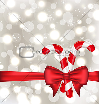 Christmas glowing background with gift bow and sweet canes