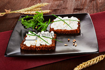 Dark bread slices with cottage cheese. Delicious healthy breakfa