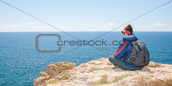 Young woman on the cliff