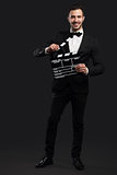 Business man holding a clapboard
