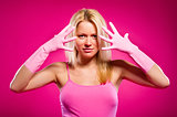 Woman wearing rubber gloves posing over pink background