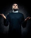 Portrait of priest against dark background
