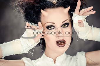 Portrait of beautiful horned woman with bright makeup