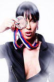 Beautiful stylish woman holding a medal