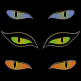 Three pairs of cat eyes over black