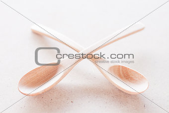 Empty spoons on brown background