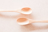 New wooden spoons on brown background