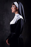 Young attractive nun indoors