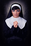Young attractive nun praying