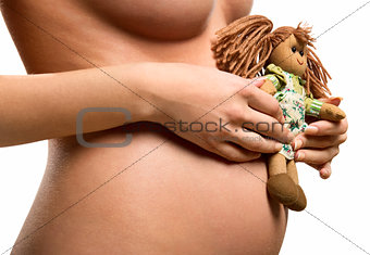 Pregnant woman holding a doll