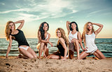 Five sexy ladies posing on the beach