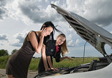 Two young women with broken car
