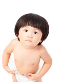 cute baby girl in a diaper standing and looks up