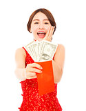 asian young woman holding a red envelope of dollar