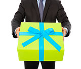 Businessman holding a gift. isolated on white