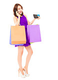 beautiful woman with shopping bags talking on phone