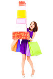 beautiful young woman holding shopping bag and gift boxes