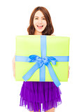 happy young woman holding a gift box over white background