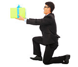 young Business man holding a gift box and kneel. 
